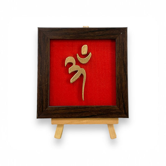 Vastu Aum 
Symbol in Metal on Red silk backdrop with a display stand.