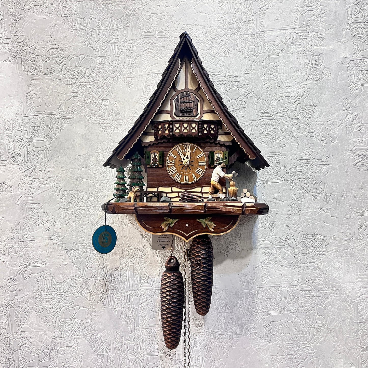 Mechanical original cuckoo clock with wood cutter with pine trees and dog miniature - 8 day Movement