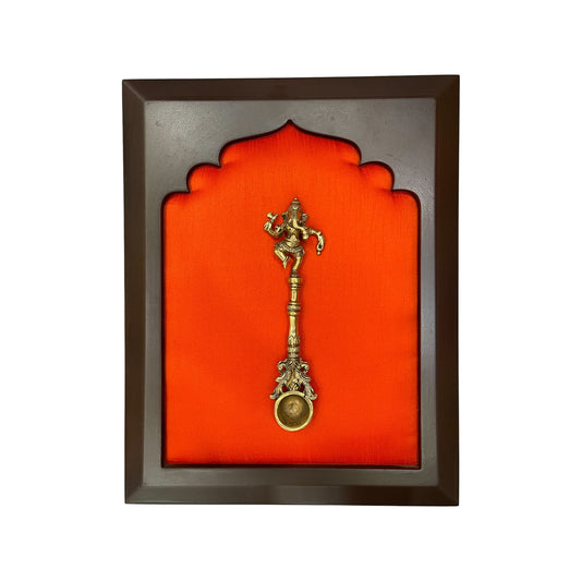Brass Ganesha Tirtha on Dark Orange in Wooden Frame – Spiritual Wall Décor