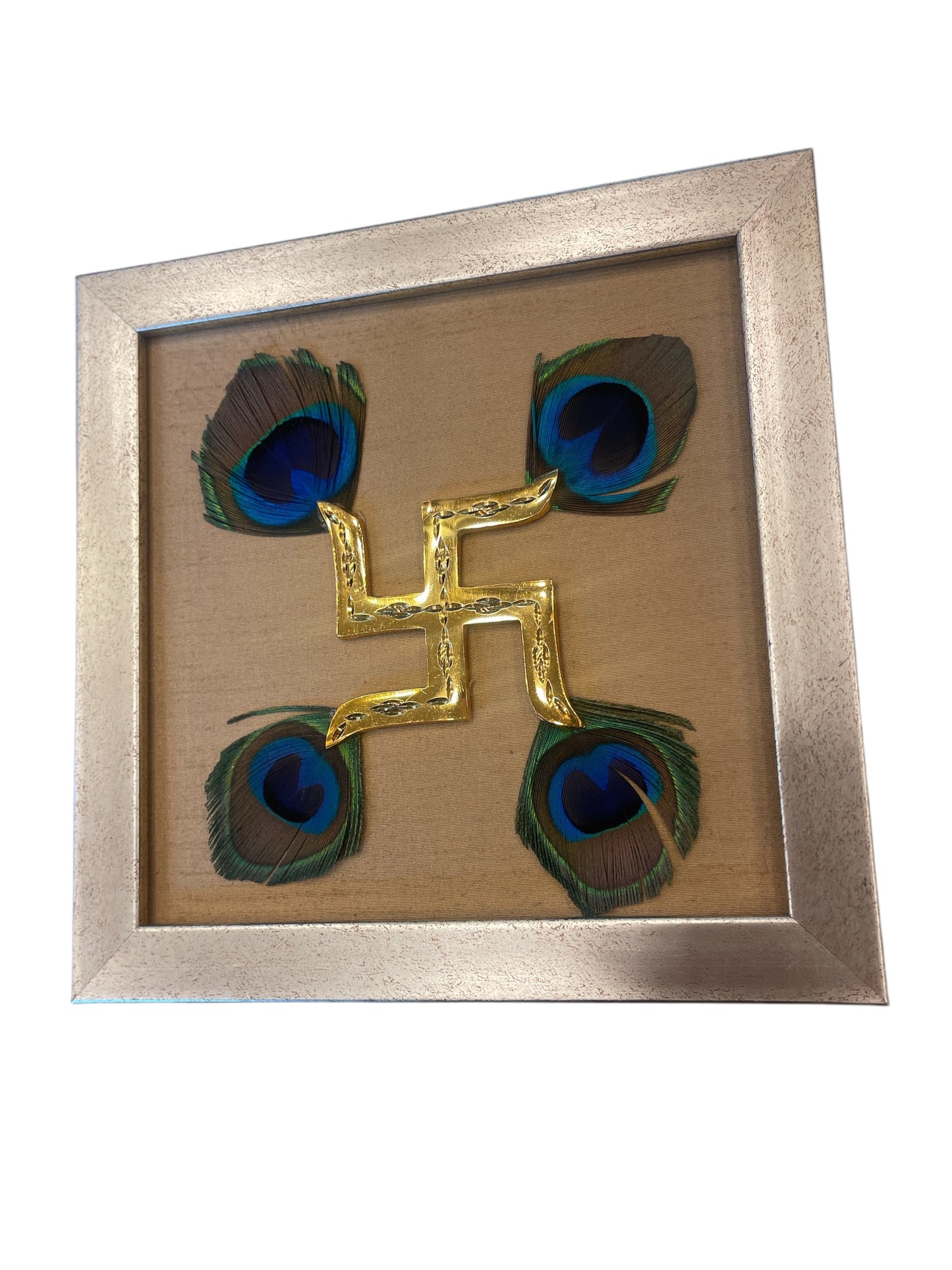 Brass swastik with Golden silk and peacock Feather in. Antique gold frame