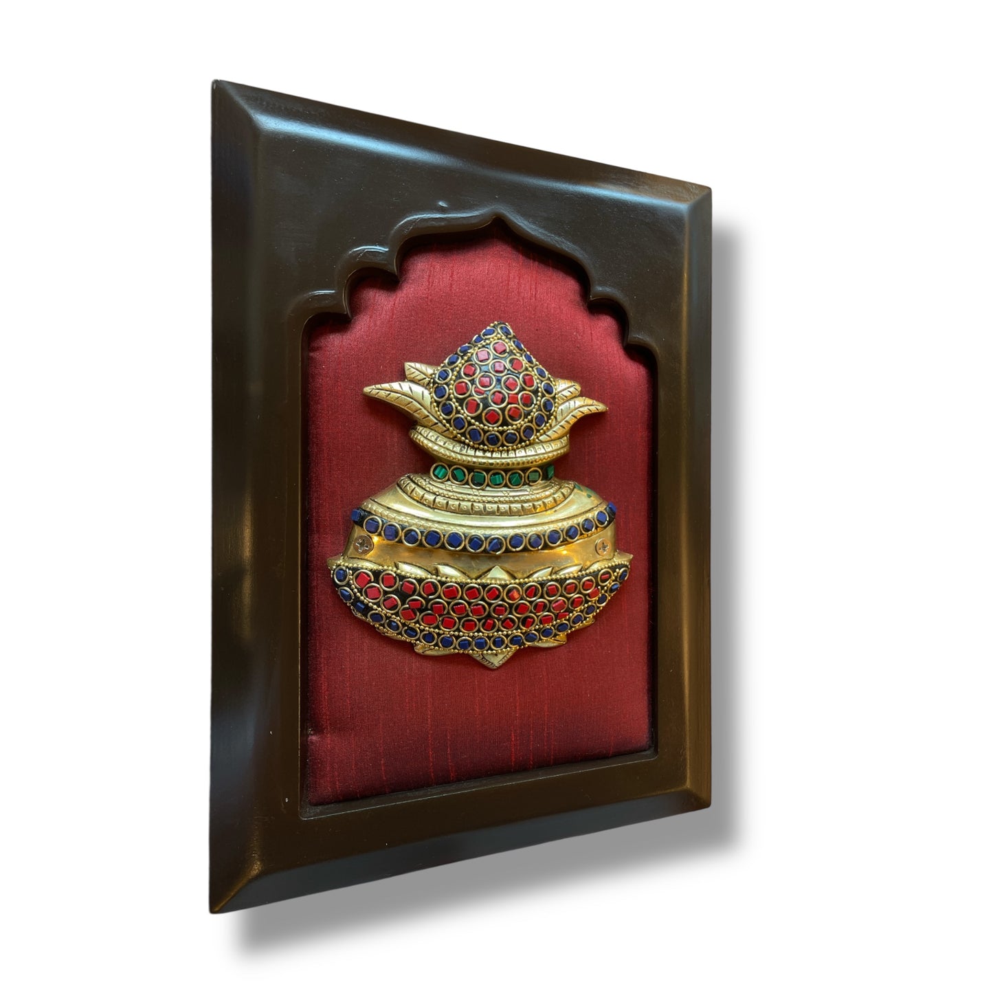 Brass kuber kalash with stone work on wine red silk in wooden frame