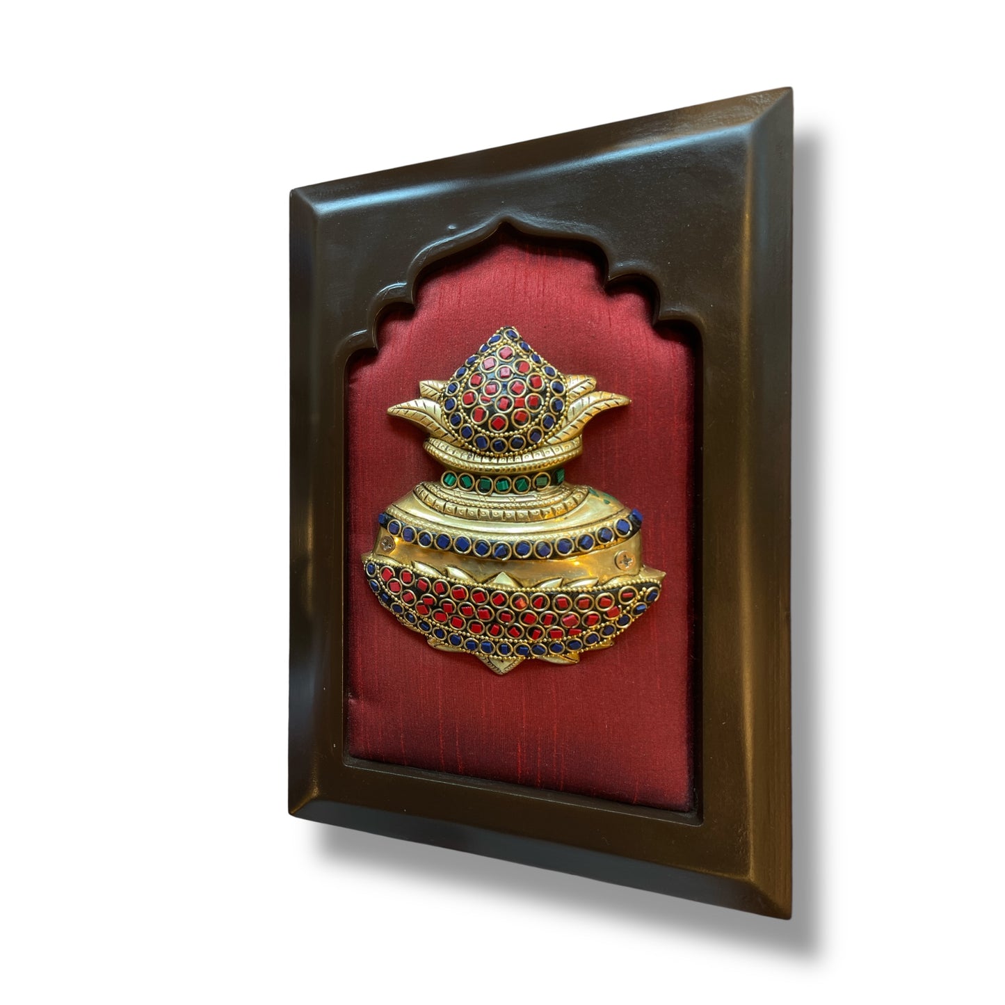 Brass kuber kalash with stone work on wine red silk in wooden frame
