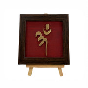 Vastu Aum 
Symbol in Metal on Wine red silk backdrop.