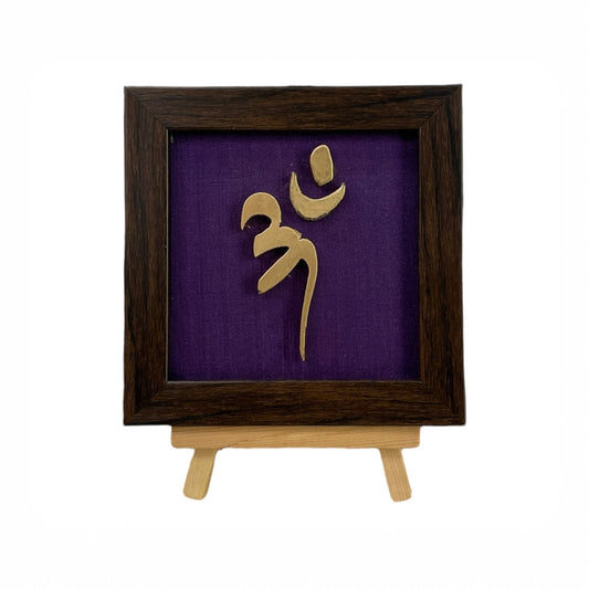 Vastu Aum 
 Symbol in Metal on Purple silk backdrop.