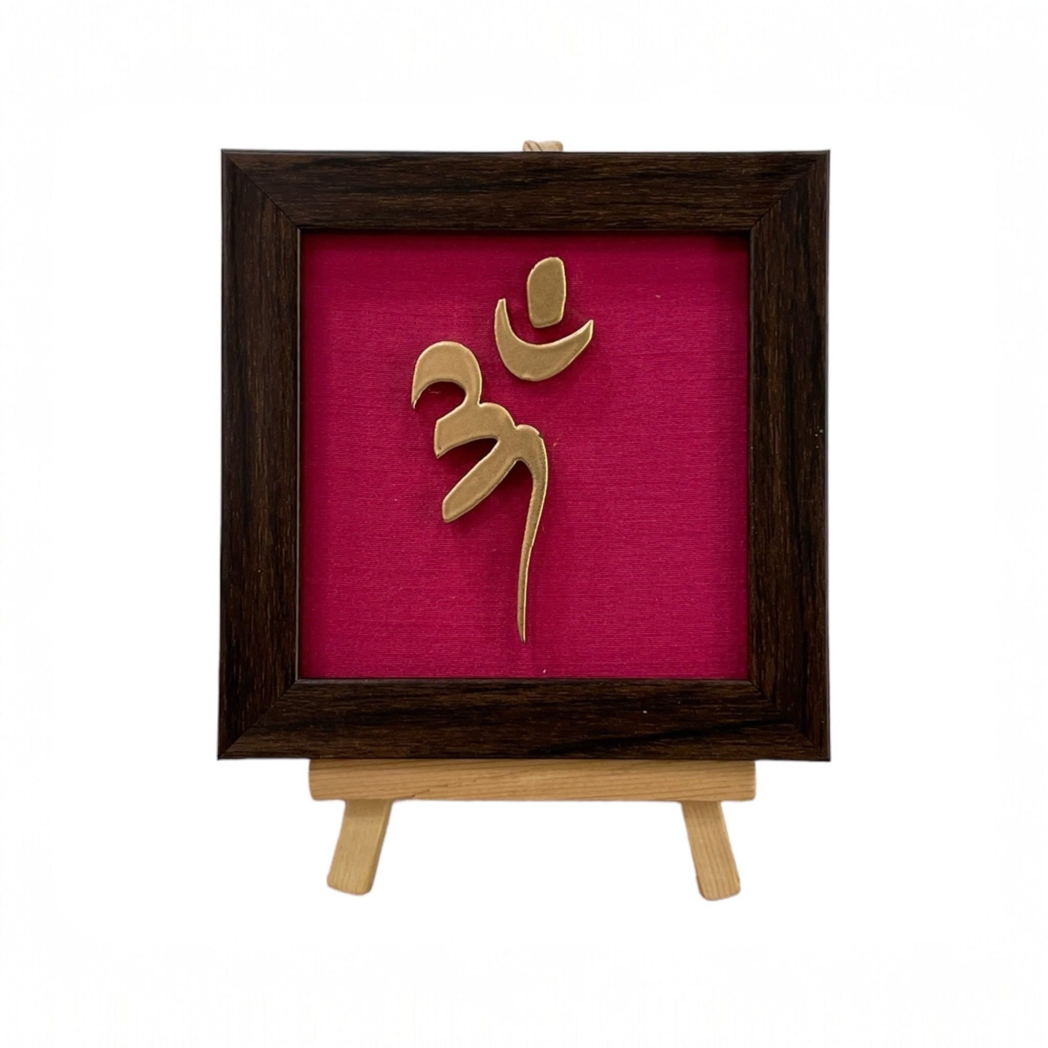 Vastu Aum 
 Symbol in Metal on Rani pink silk backdrop.