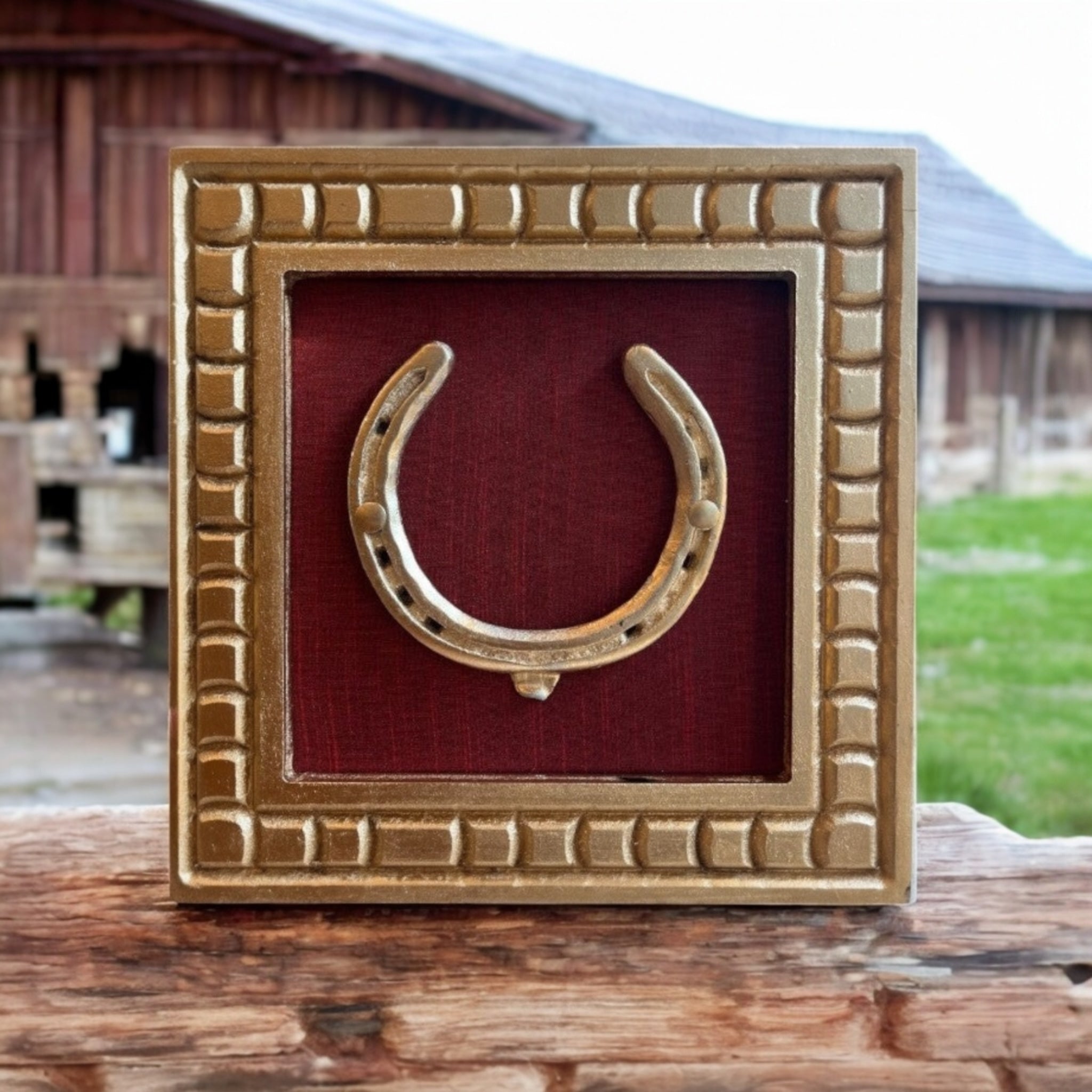 Good Luck Brass Horse Shoe with a wine red silk background with gold wooden frame