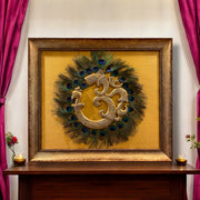Brass Om with Peacock Feathers on Golden Silk in Moulded Frame
