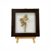 Vastu Aum 
 Symbol in Metal on white silk backdrop with a display stand.