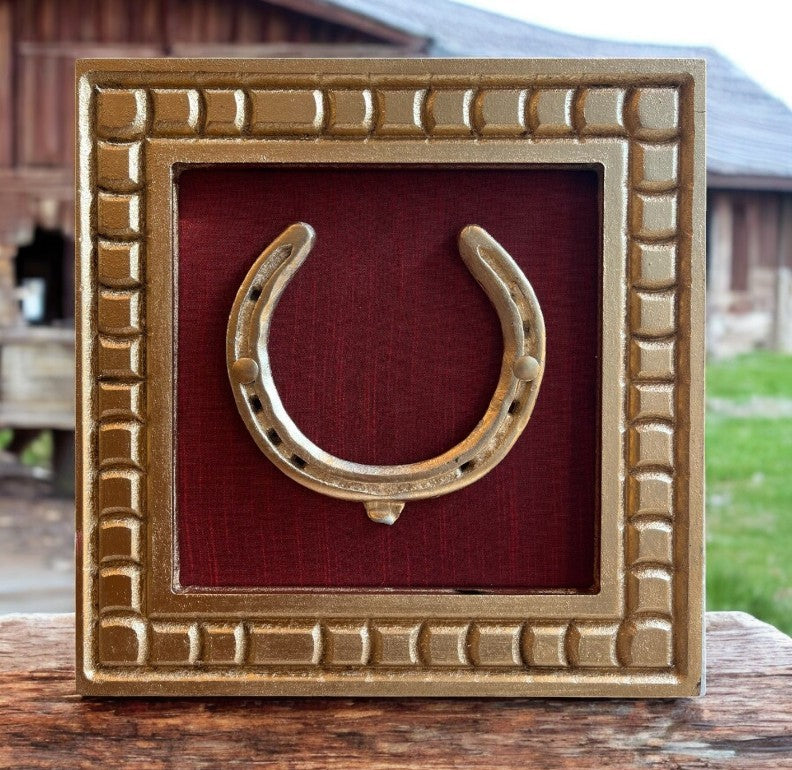 Good Luck Brass Horse Shoe with a wine red silk background with gold wooden frame