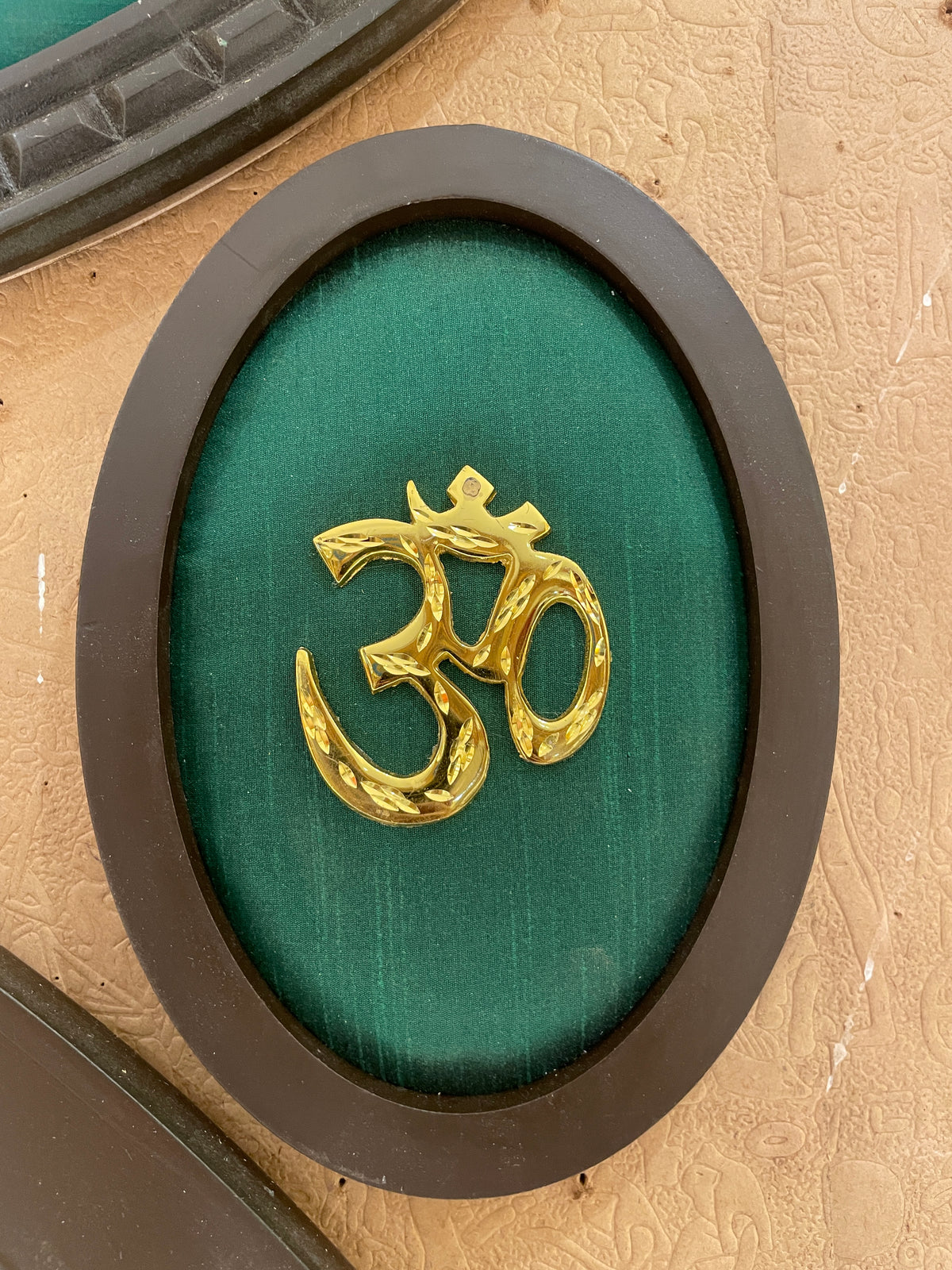 Om Metal Wall Art with Premium Engineered Wooden Frame | Golden Om Symbol on Green Silk | Spiritual Home & Pooja Room Décor | Made by ESTUDIO