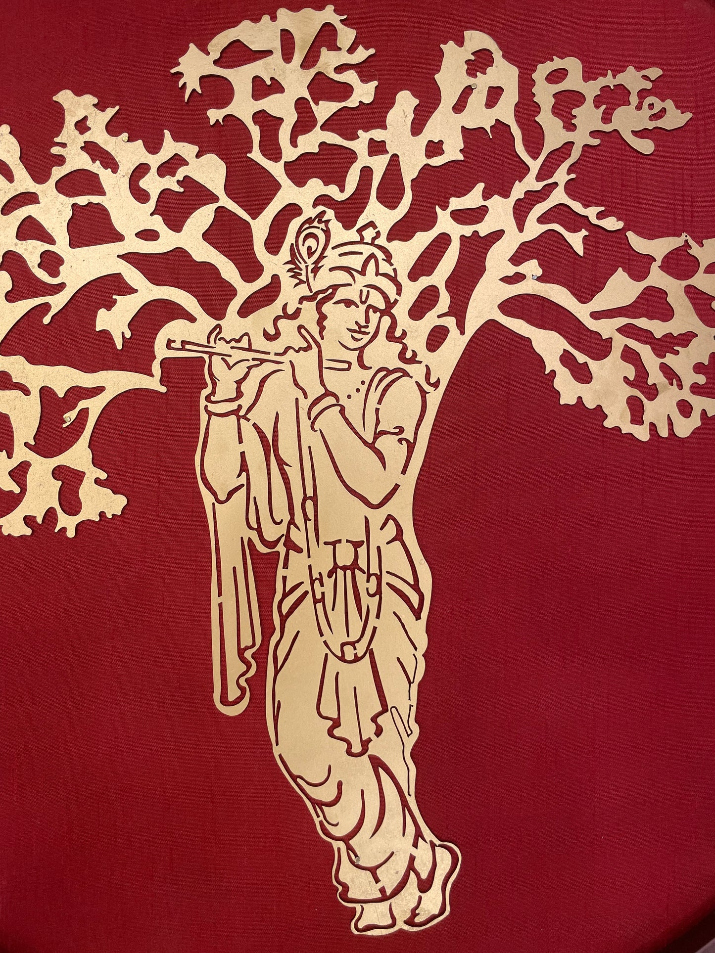 Krishna Beneath The Kalpavriksha with Wine Red silk Background within a circular Frame