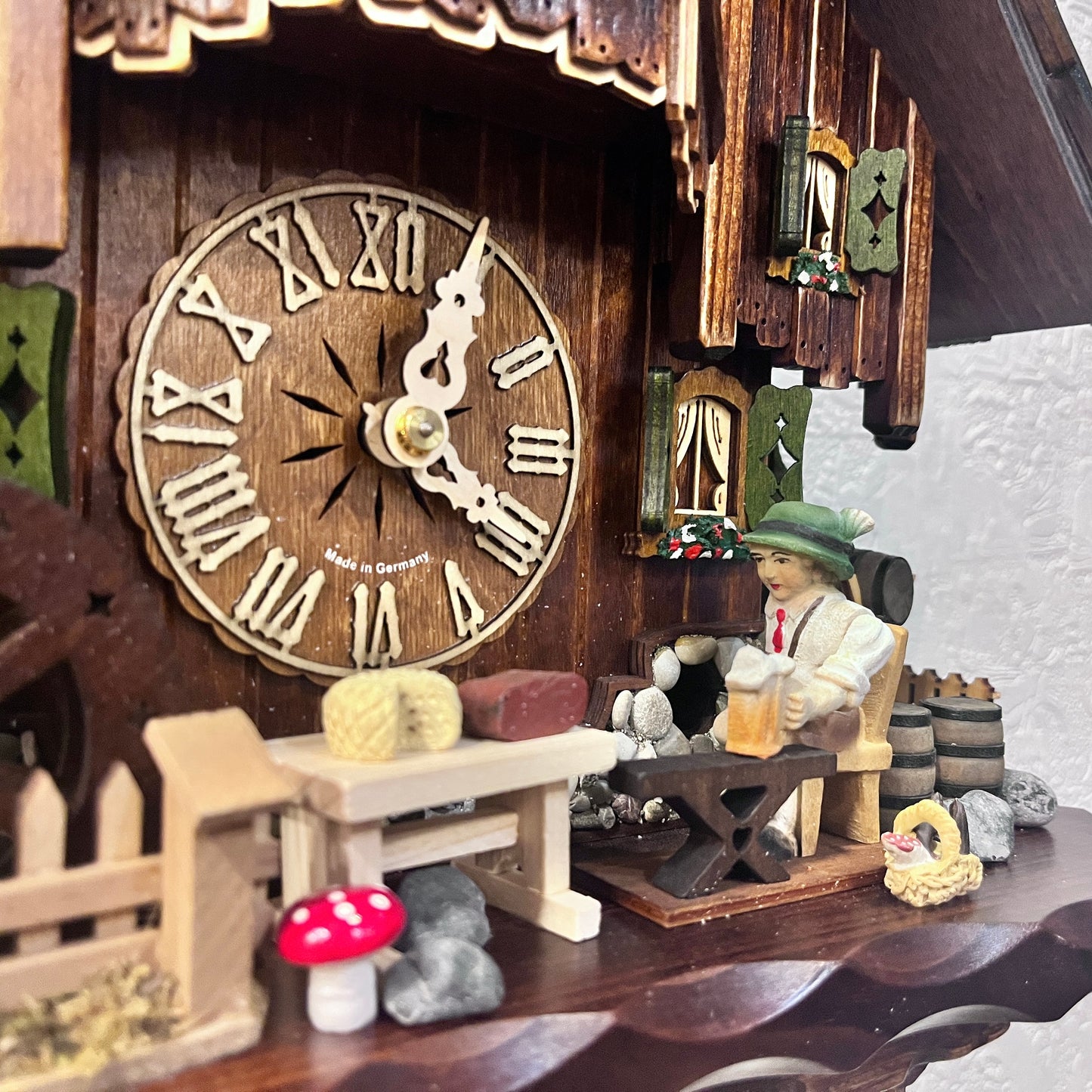 Musical cuckoo clock with beer drinking man ,German farm dance along with moving water wheel.