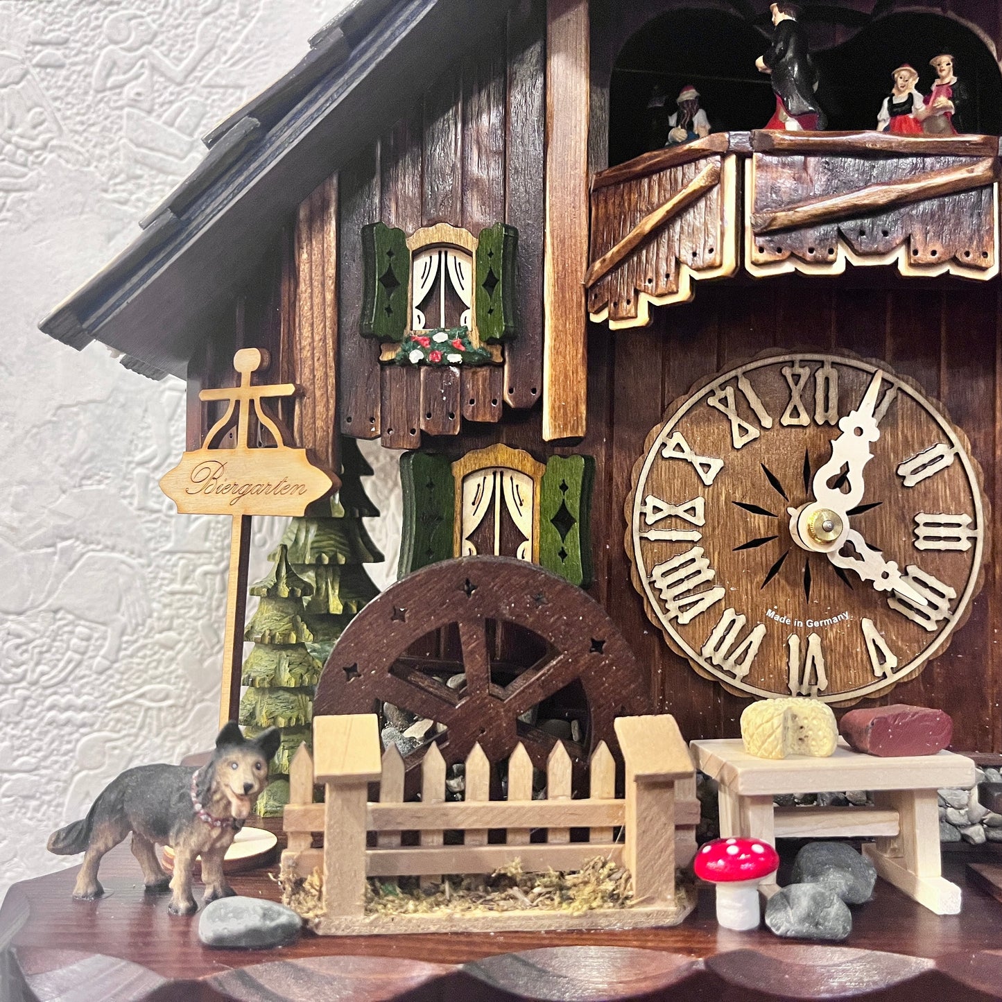 Musical cuckoo clock with beer drinking man ,German farm dance along with moving water wheel.