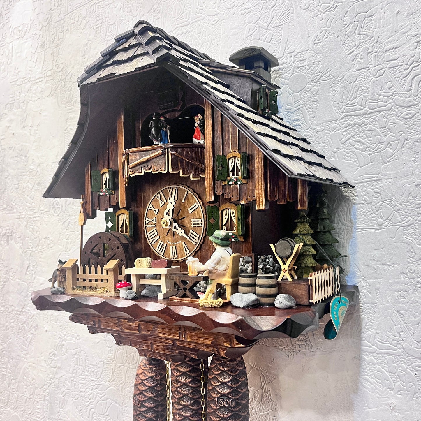 Musical cuckoo clock with beer drinking man ,German farm dance along with moving water wheel.