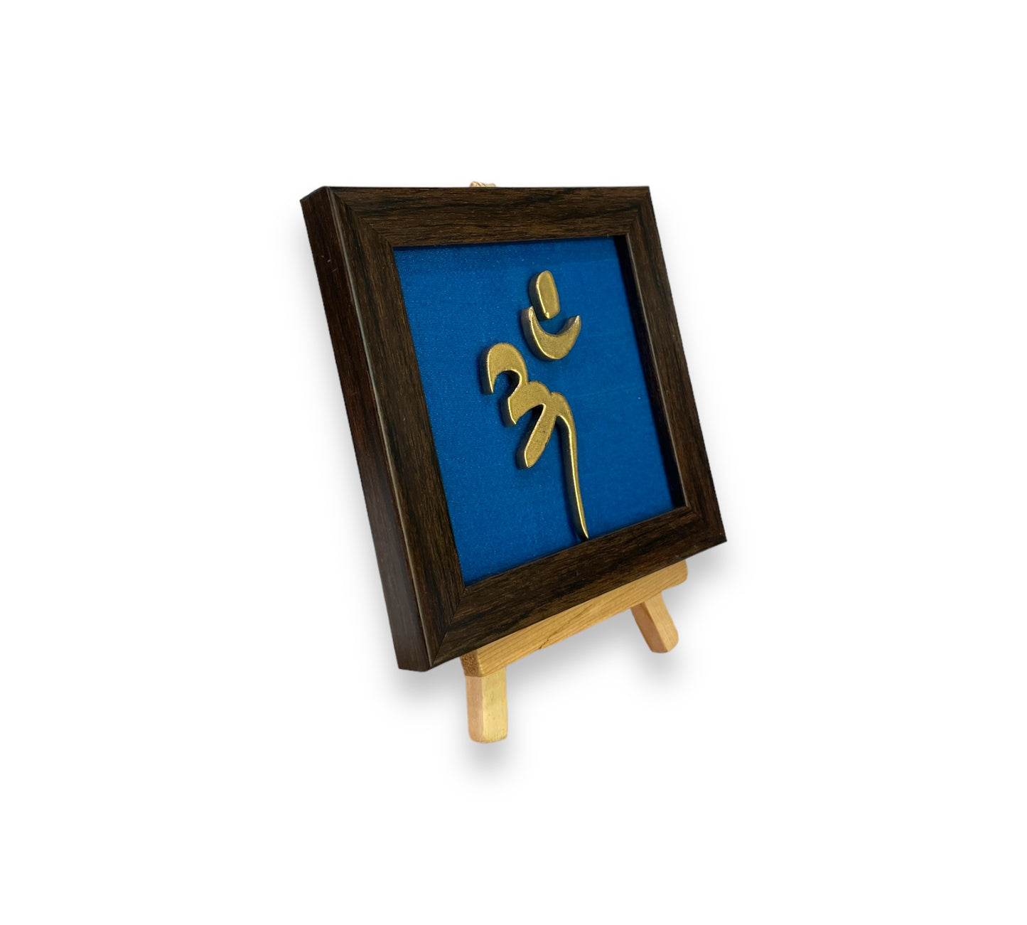 Vastu Aum 
Symbol in Metal on blue silk backdrop with a display stand.