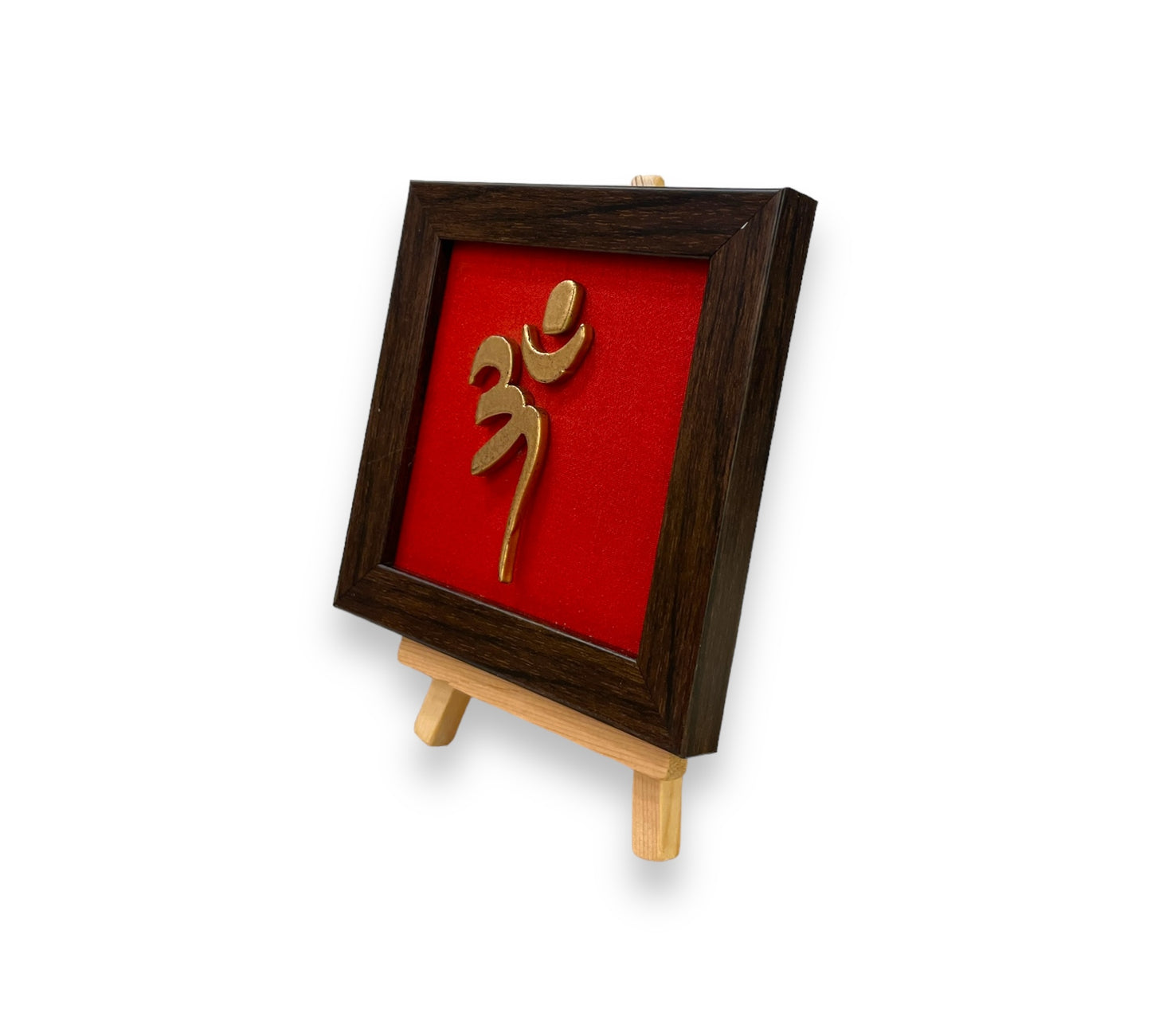 Vastu Aum 
Symbol in Metal on Red silk backdrop with a display stand.