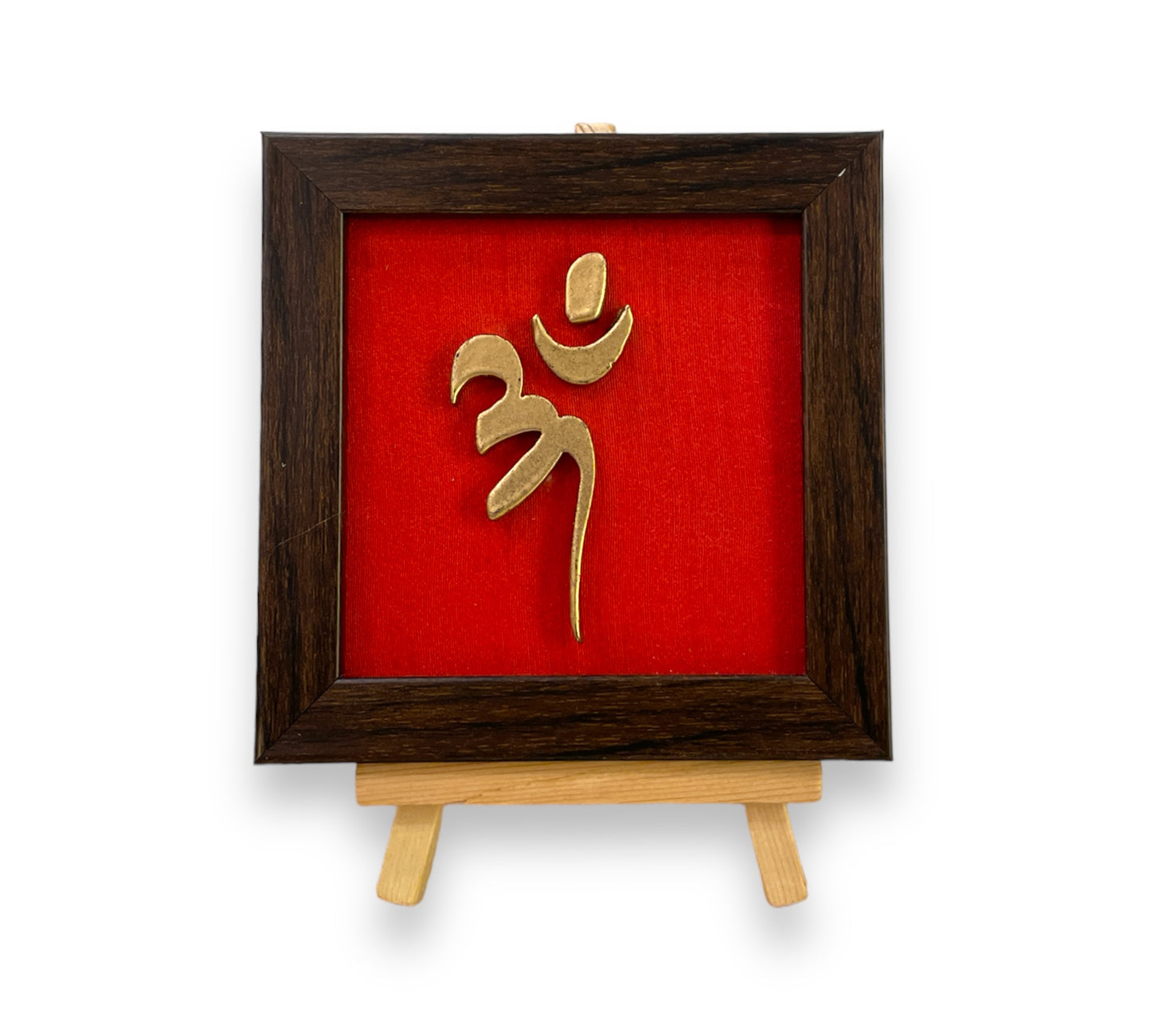 Vastu Aum 
Symbol in Metal on Red silk backdrop with a display stand.