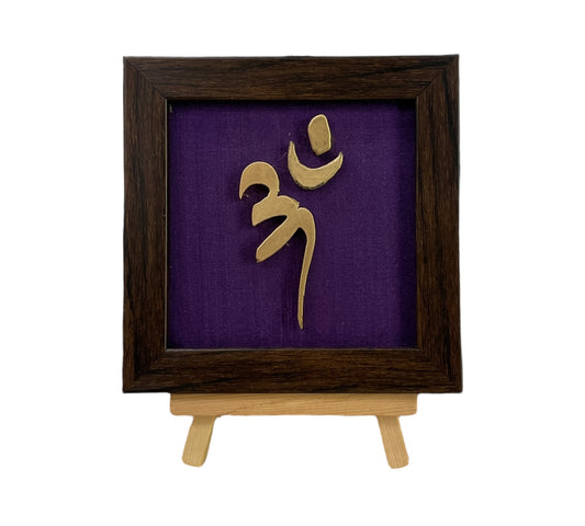 Vastu Aum 
 Symbol in Metal on Purple silk backdrop.