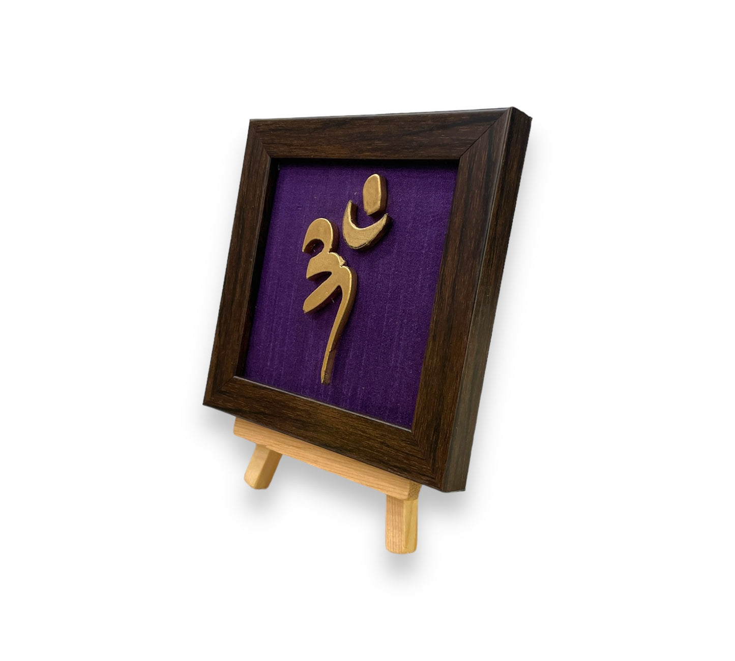 Vastu Aum 
 Symbol in Metal on Purple silk backdrop.