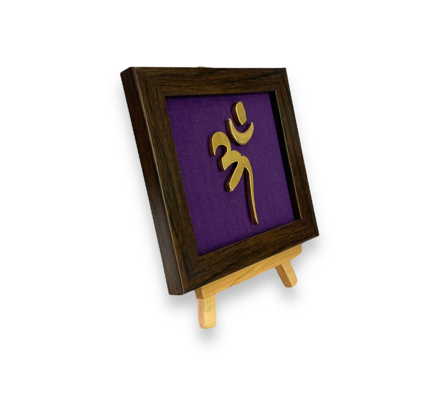 Vastu Aum 
 Symbol in Metal on Purple silk backdrop.