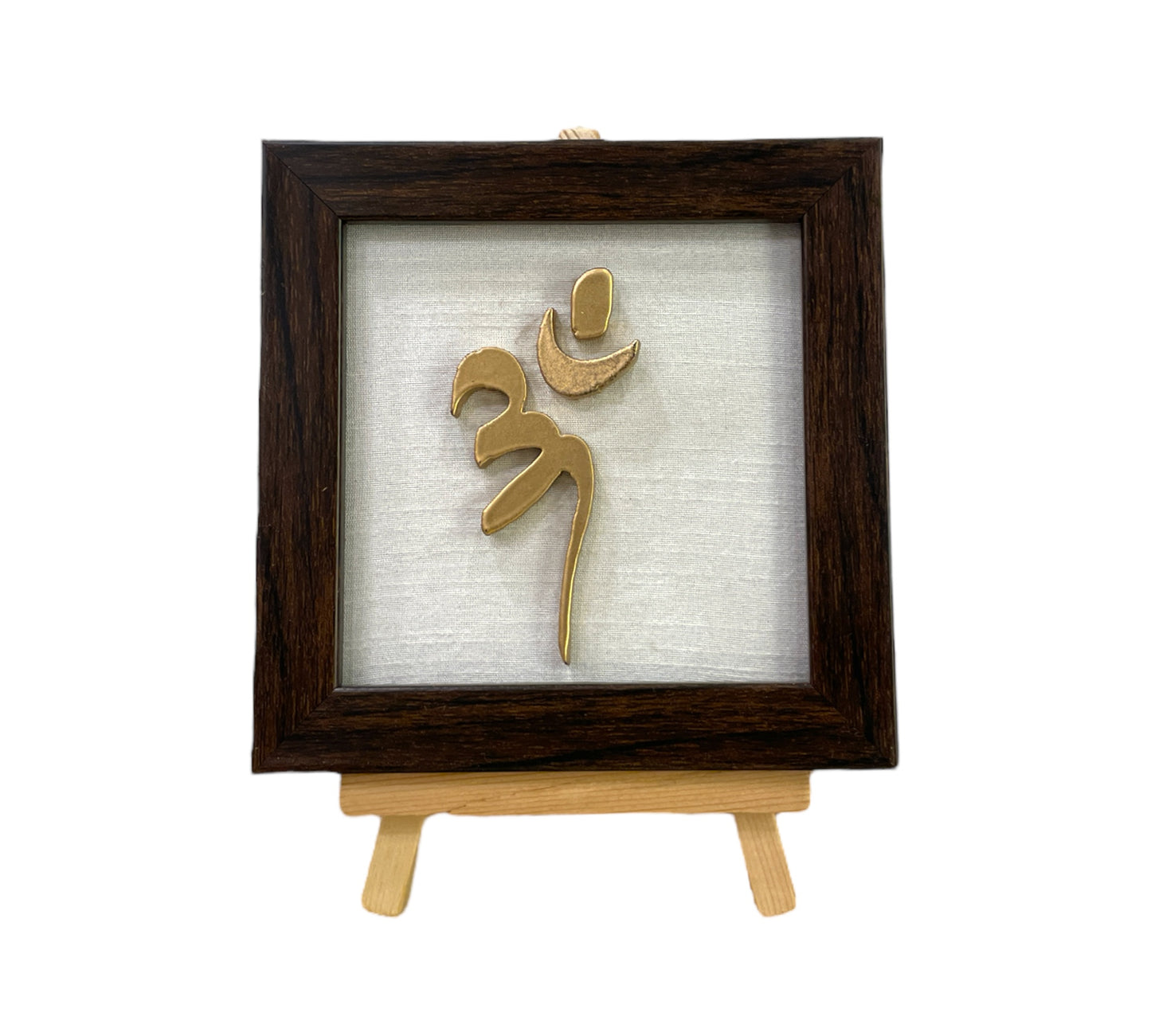 Vastu Aum 
 Symbol in Metal on white silk backdrop with a display stand.