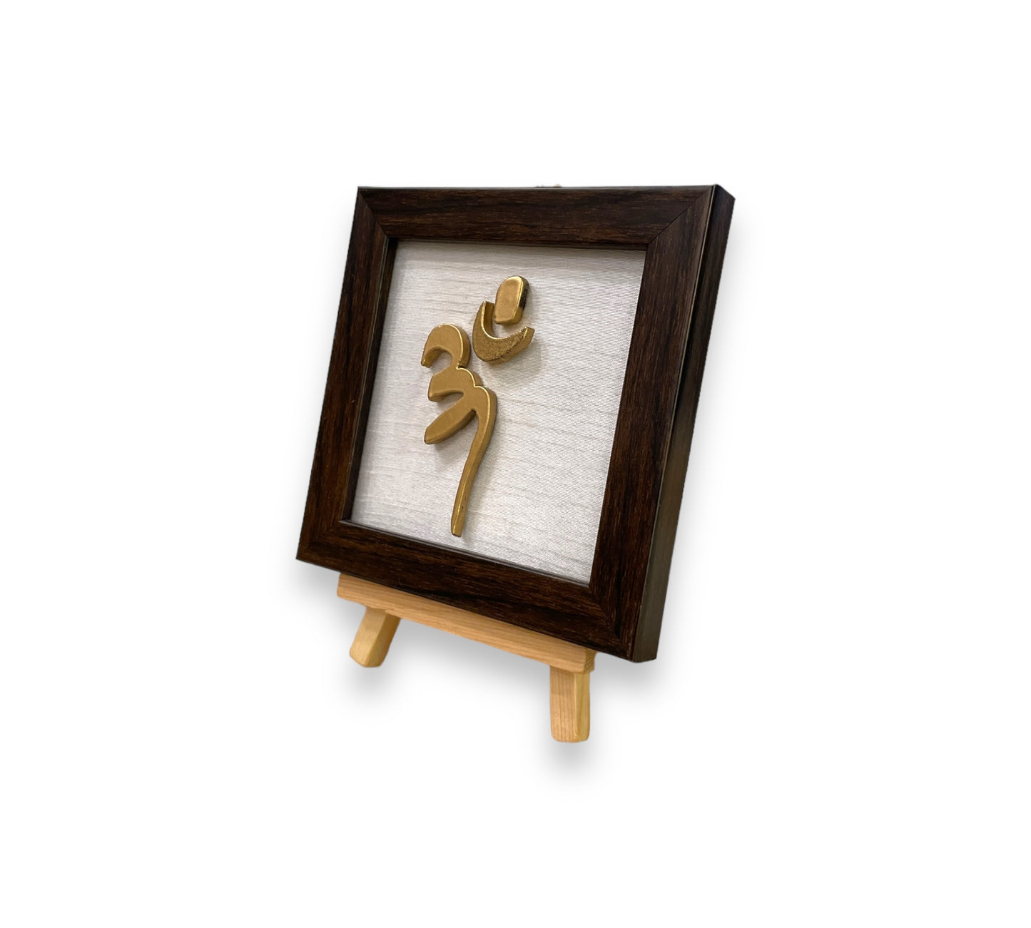 Vastu Aum 
 Symbol in Metal on white silk backdrop with a display stand.