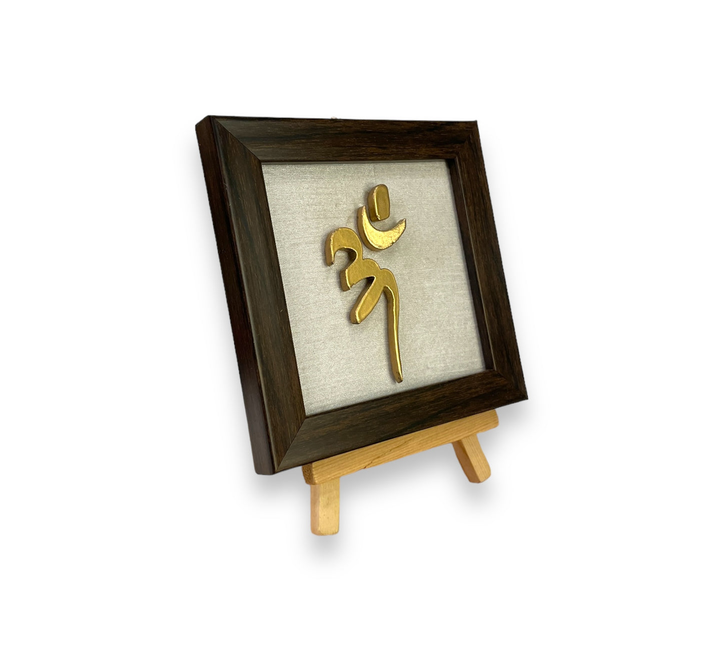 Vastu Aum 
 Symbol in Metal on white silk backdrop with a display stand.