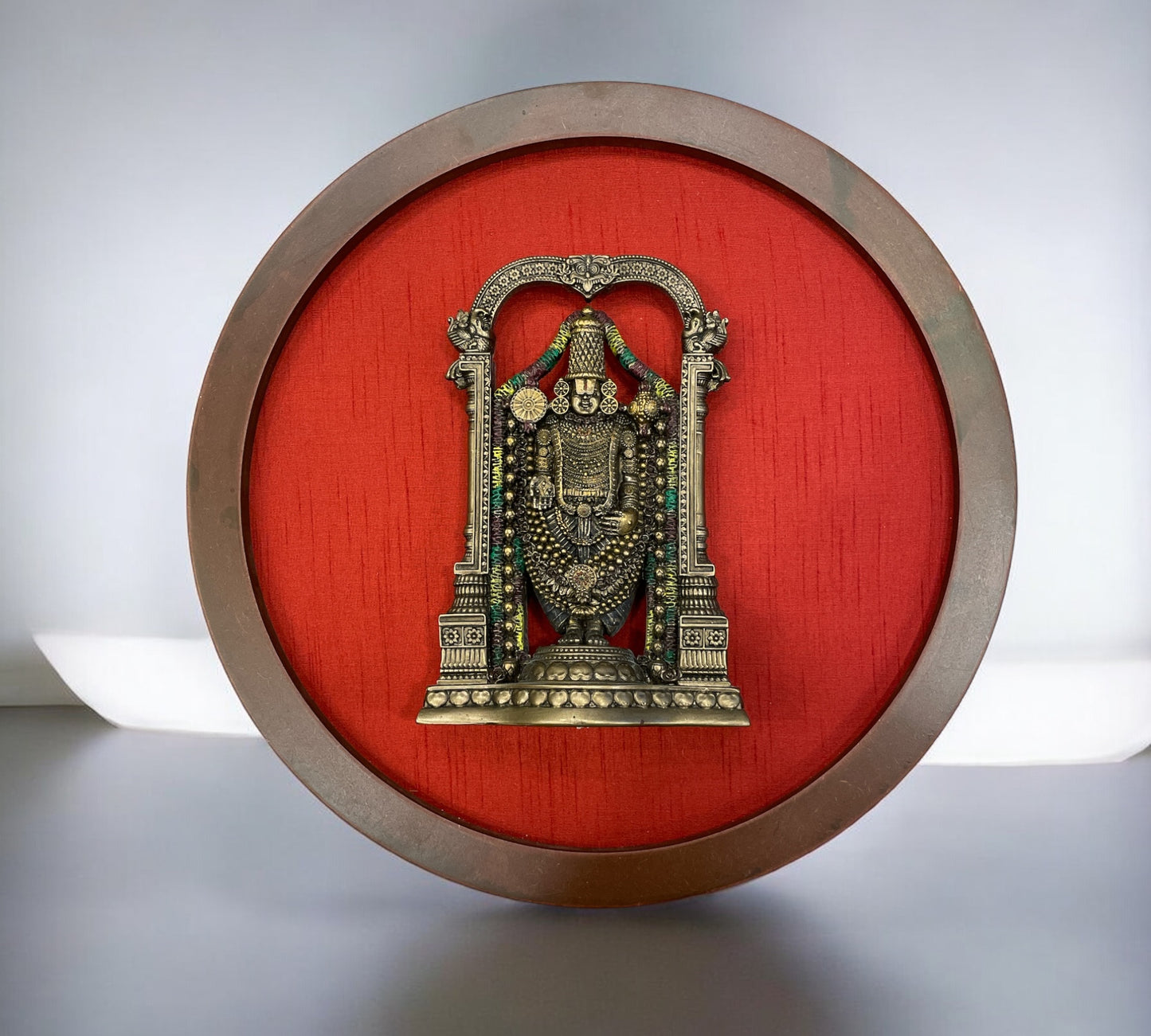 Bronze Venkateshwara Swamy Idol In a Circle Frame With Wine red Silk Background