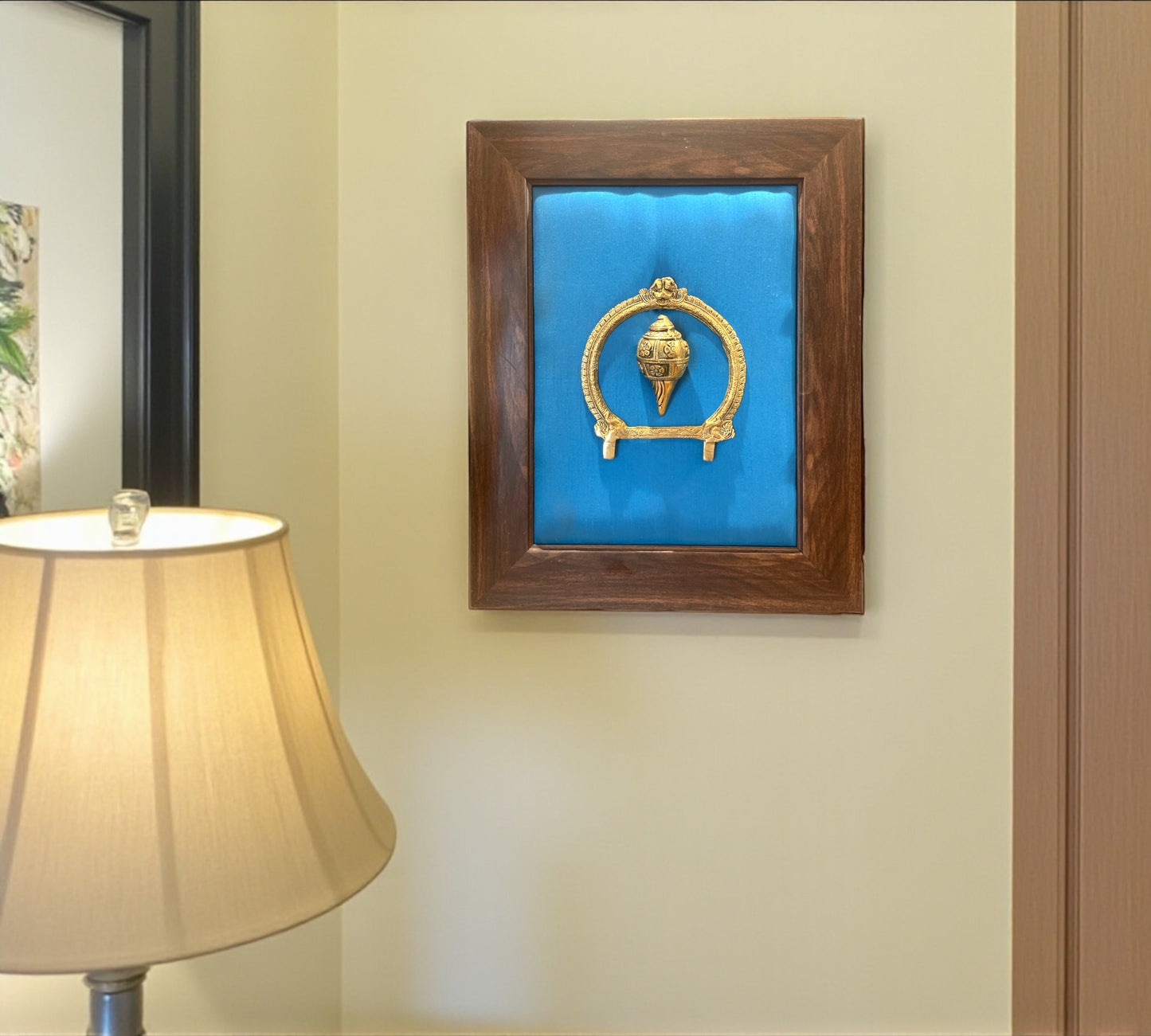 Brass Conch and Prabavali with Blue Cushion Backdrop in Brown frame