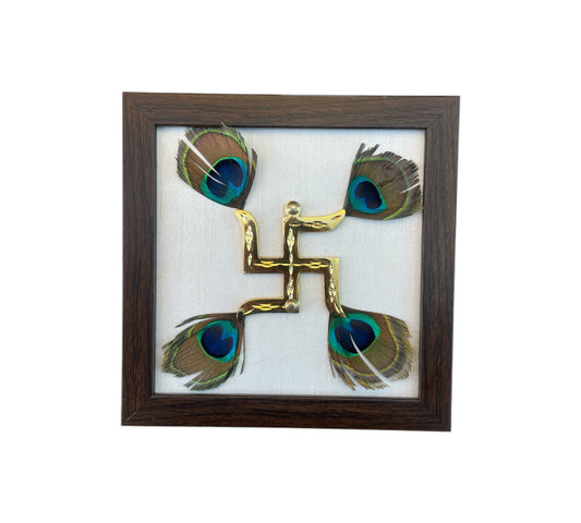 Brass Swastik with Peacock Feather and White silk in Brown Frame