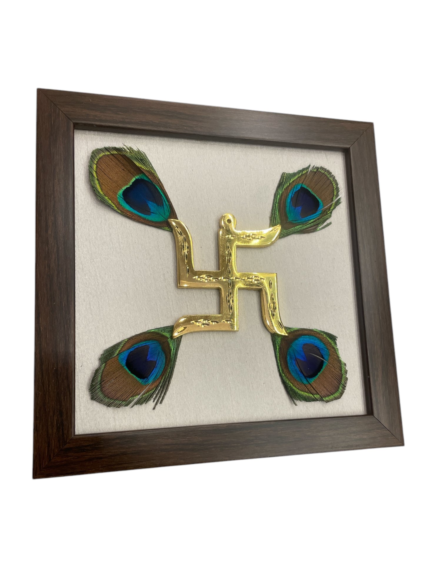 Brass swastik with peacock feather & white silk in Brown frame