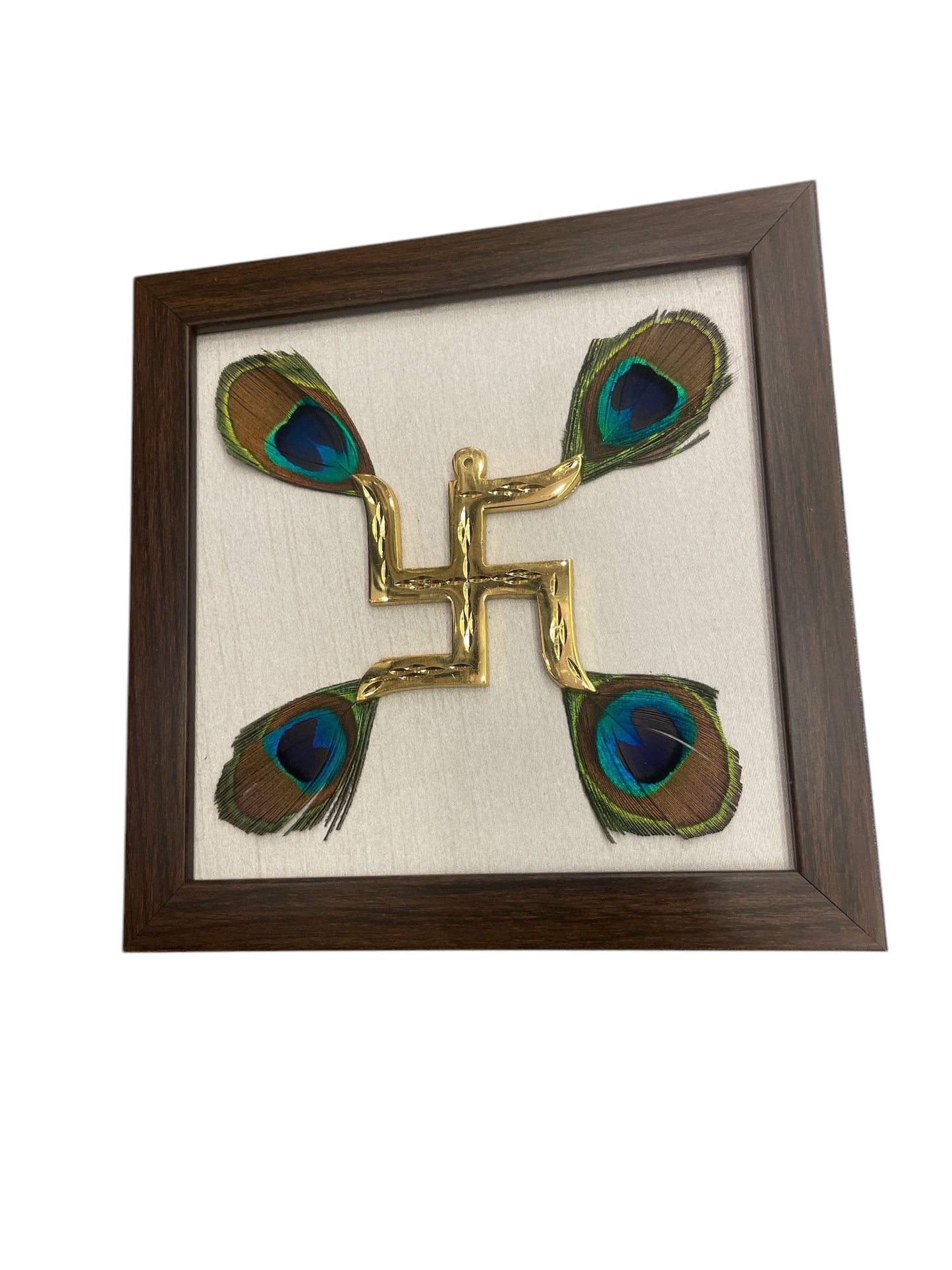 Brass swastik with peacock feather & white silk in Brown frame