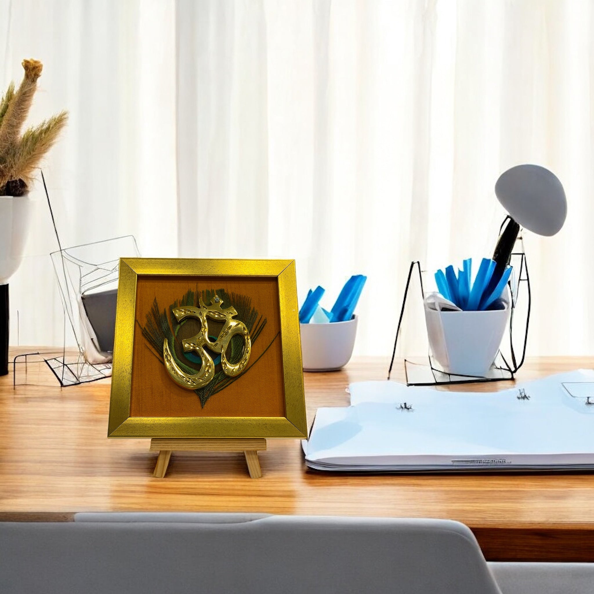 Brass Om on Peacock Feather & Orange Silk with display stand