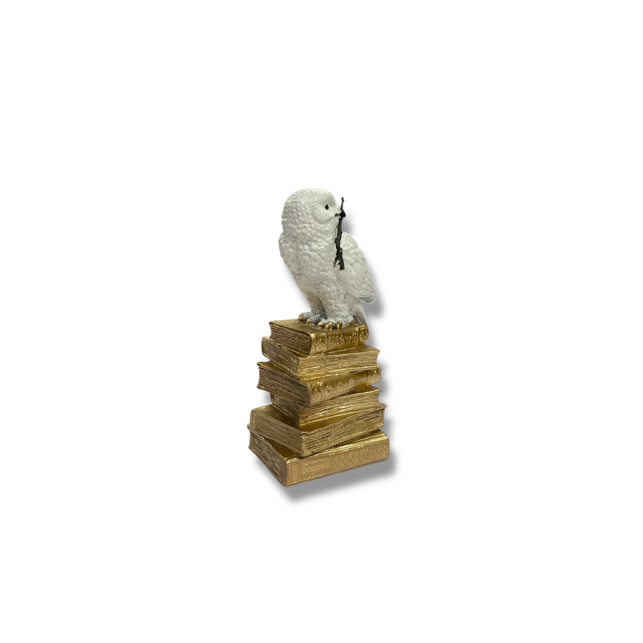 White Owl Figurine on a Stack of Golden Books
