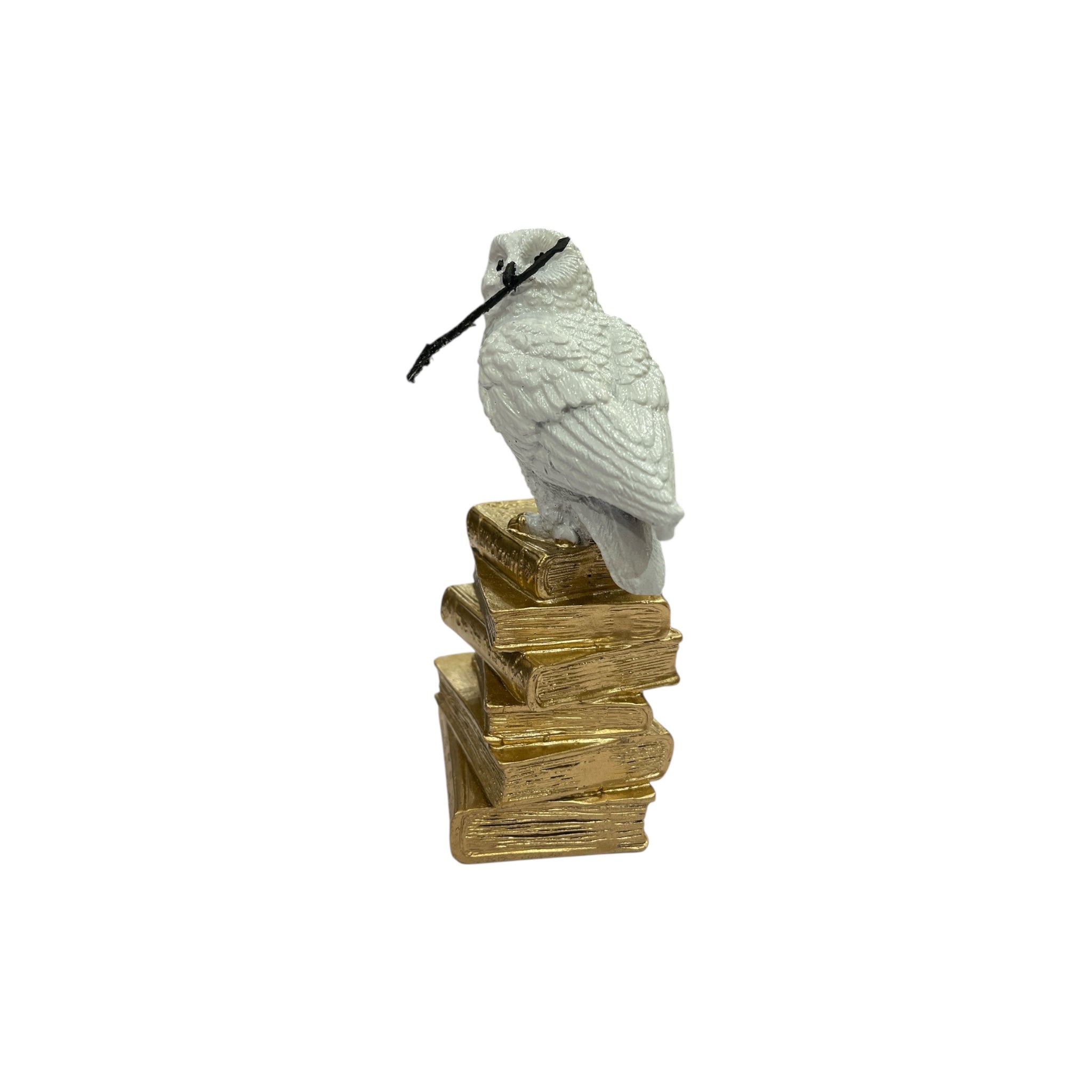 White Owl Figurine on a Stack of Golden Books