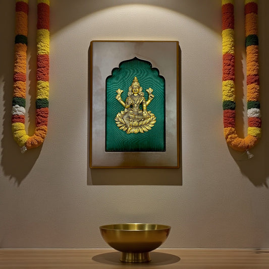 brass lakshmi with green silk backdrop.