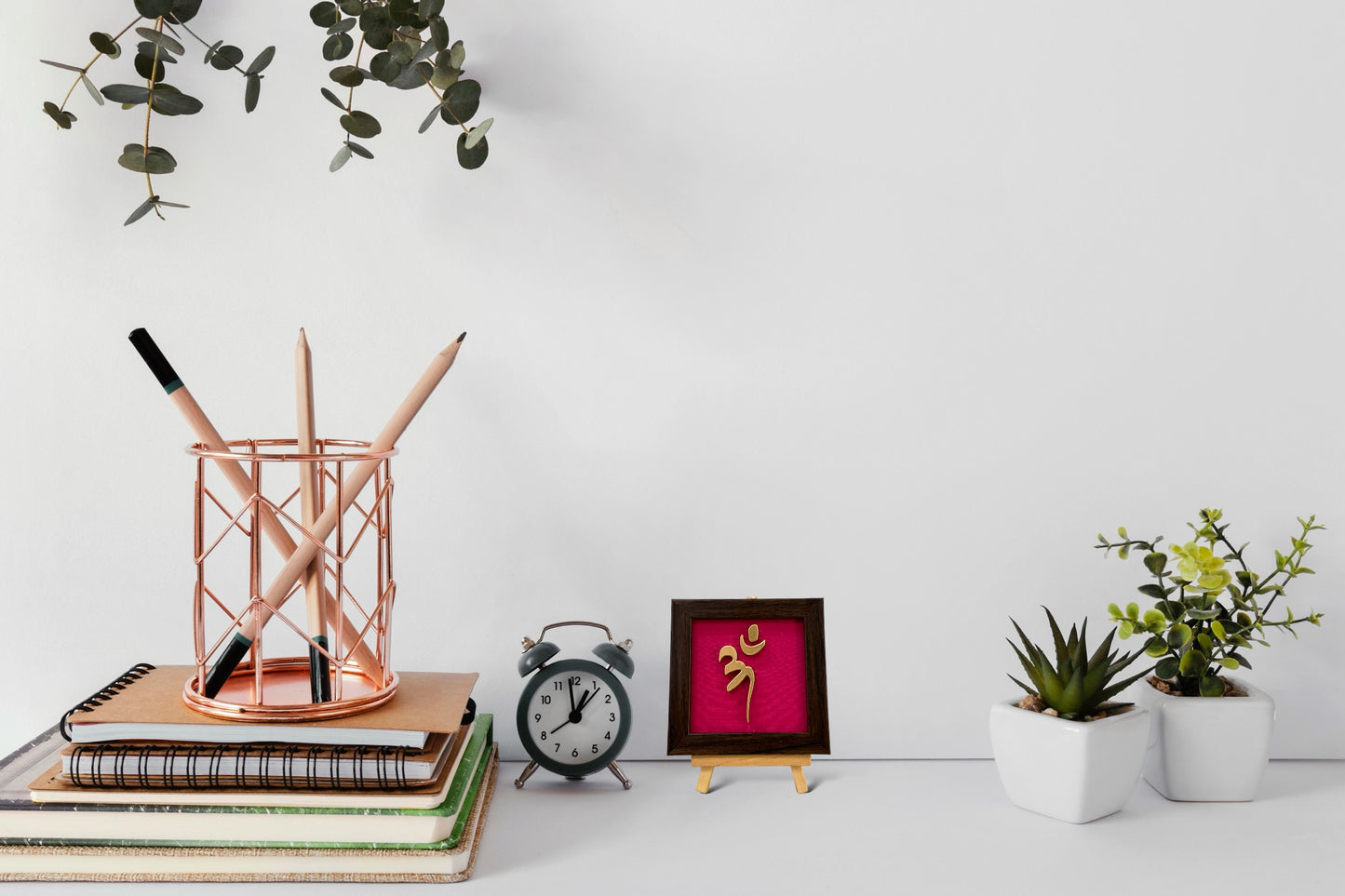 Vastu Aum 
 Symbol in Metal on Rani pink silk backdrop.