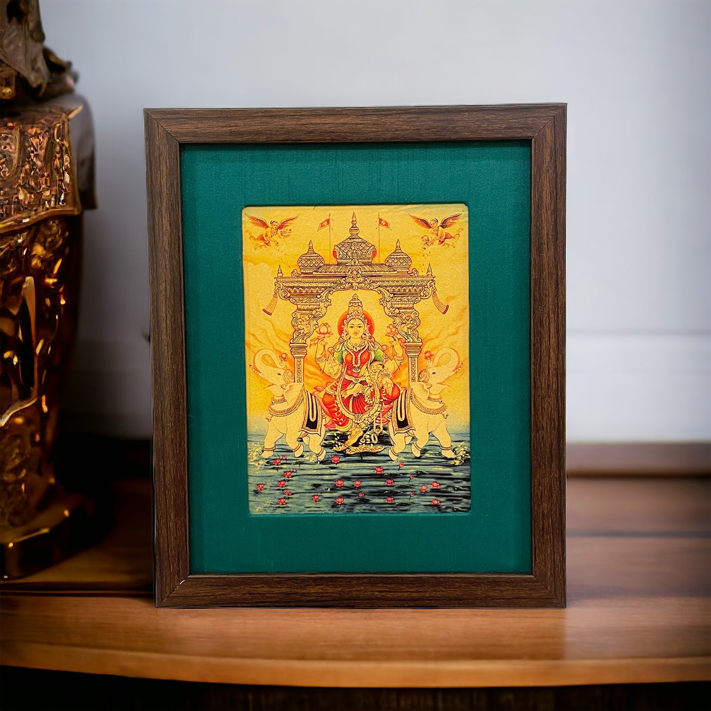 Verdant Blessings: Gajalakshmi Devi's Divine Presence in Green Silk With Brown Frame