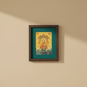 Verdant Blessings: Gajalakshmi Devi's Divine Presence in Green Silk With Brown Frame