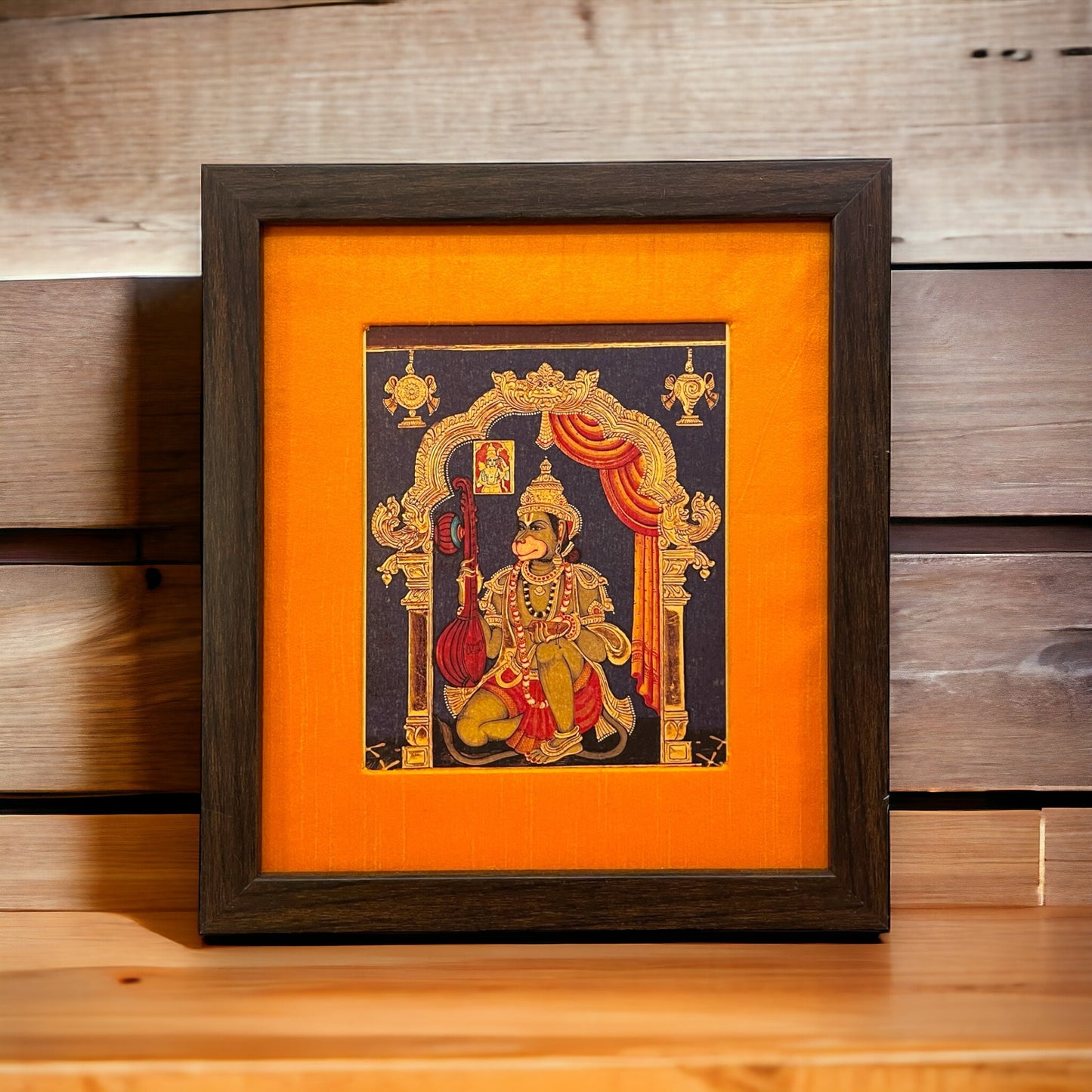 Divine Musician Hanumaan with Veena: 22crt gold leaf paper photo orange silk with brown frame