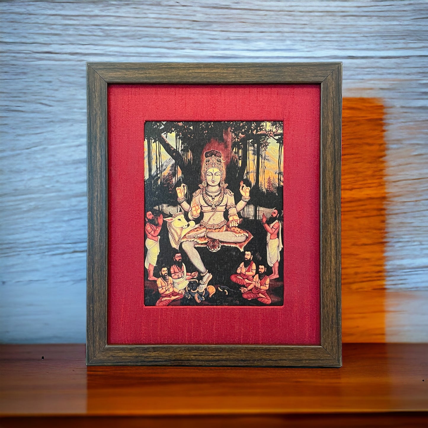 Sacred Wisdom Unveiled: God Dakshinamurthy Presence in Red Silk With Brown Frame