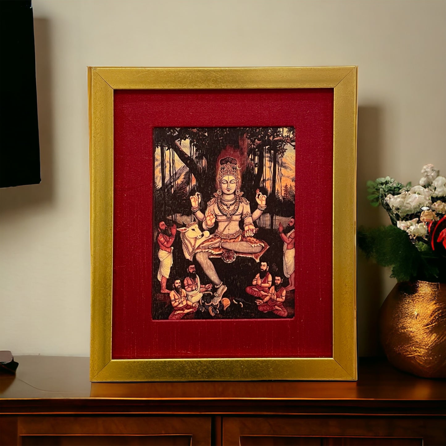 Sacred Illumination: Dakshina Murthy's Wisdom in Red silk with Gold Frame