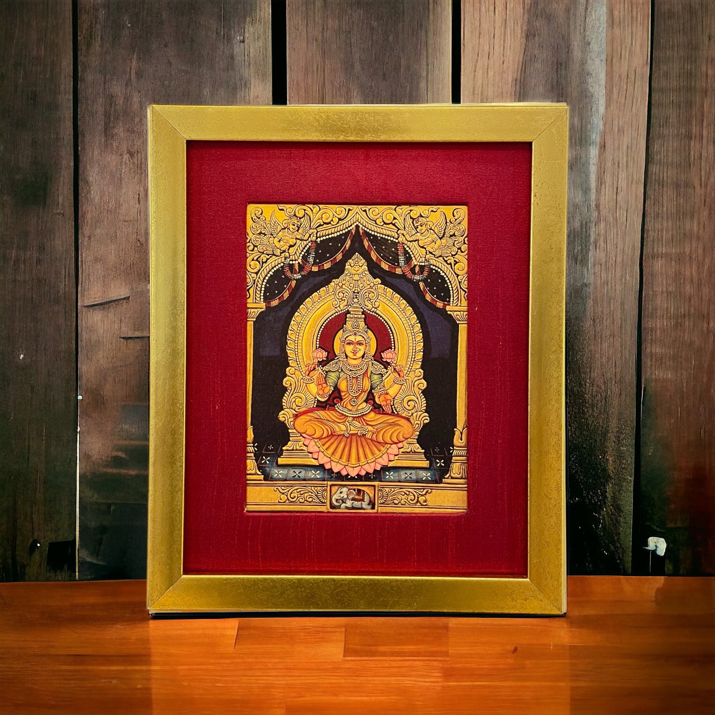 Radiant Elegance: Lakshmi Devi's Divine Presence in Red Silk with Gold Frame