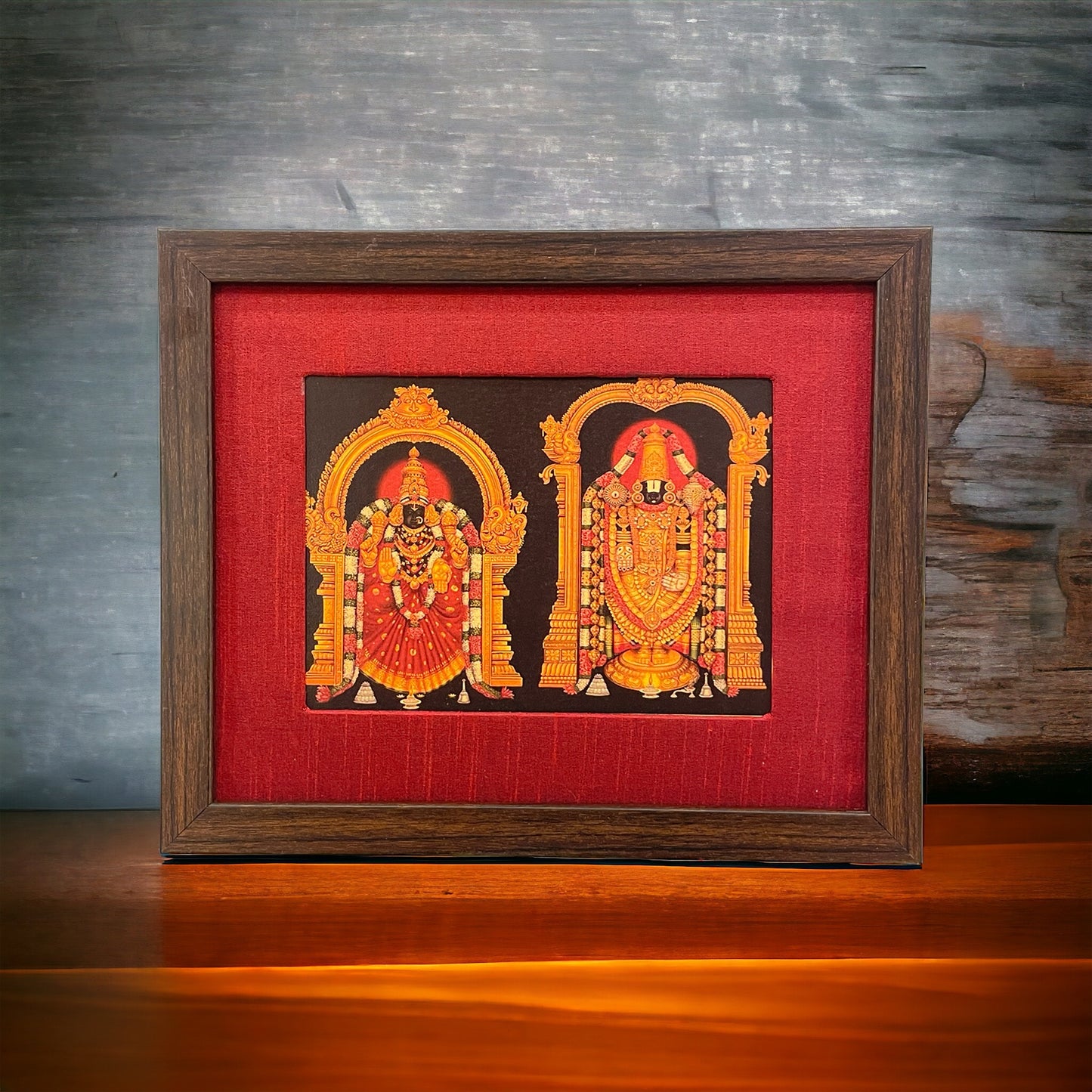 Divine Depiction of God Venkateswara and Goddess Padmavathi in Red Silk Ensemble With Brown Frame