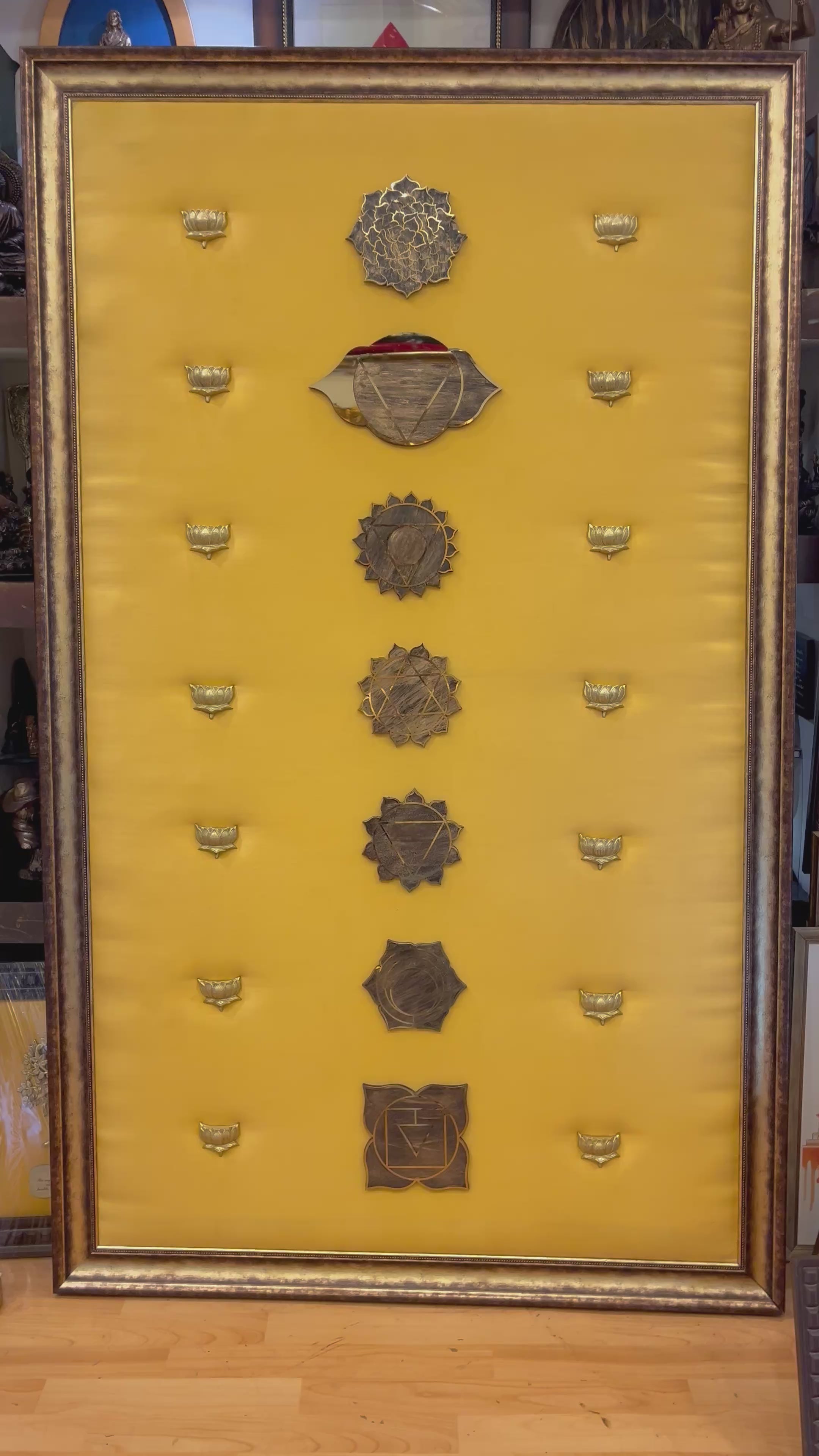 Load video: 7 Chakra Wall Art | Sacred Energy Symbols crafted in titanium with brass lotus embellishments on Golden Silk | Framed decor to make a statement.